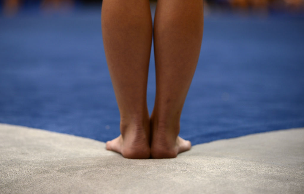 A gymnast waits to begin her floor routine